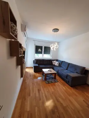 a living room with a couch and a table at Apartman Lux Doboj 2 in Doboj