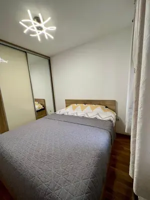 a bedroom with a bed and a ceiling fan at Apartman Lux Doboj 2 in Doboj