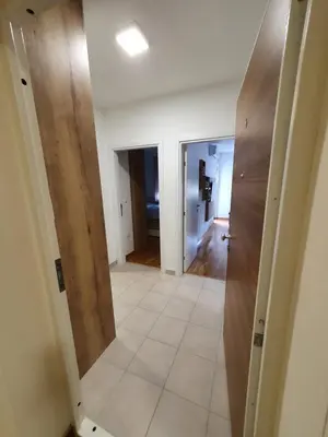 a hallway of a house with wooden doors at Apartman Lux Doboj 2 in Doboj