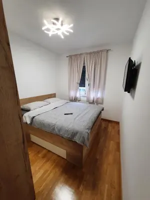 a bedroom with a bed and a chandelier at Apartman Lux Doboj 2 in Doboj