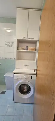 a washer and dryer in a bathroom with a cabinet at Vikendica Kod Koje in Banja Luka
