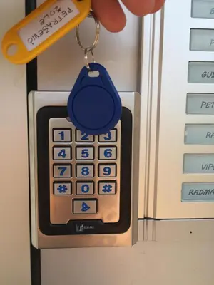 a cell phone with a blue keychain on it at Apartment Palas in Banja Luka