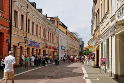 a group of people walking down a street with buildings at Apartment Palas in Banja Luka