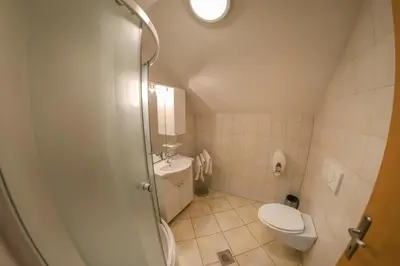 a small bathroom with a toilet and a sink at Apartments Crvena Jabuka in Ključ