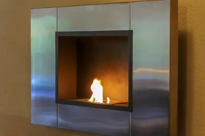a fireplace with a lit candle in it at Apartments Crvena Jabuka in Ključ