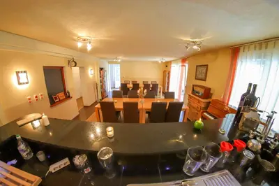 a living room with a table and a dining room at Apartments Crvena Jabuka in Ključ