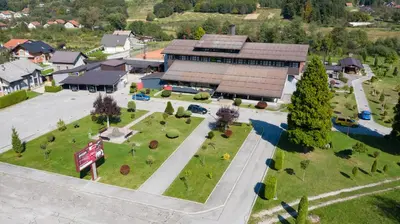 an aerial view of a building with a park at Hotel TISA in Busovača