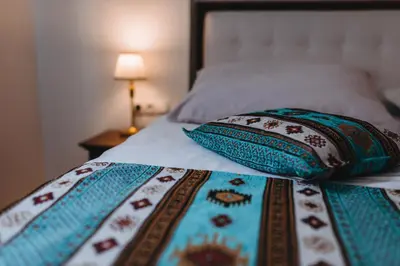 a bed with two pillows on top of it at Hotel Kostelski Buk in Bihać