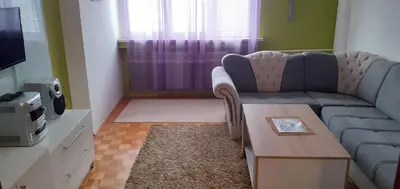 a living room with a couch and a table at Apartman centar lux in Tuzla