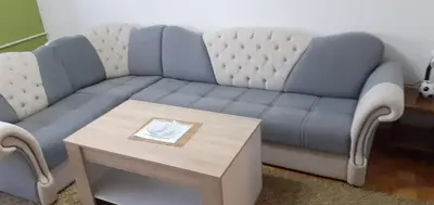 a blue couch with a coffee table in a living room at Apartman centar lux in Tuzla