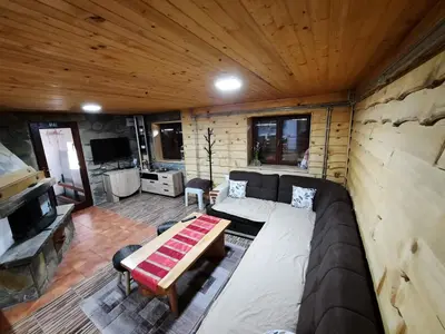 a living room with a couch and a table at Vikendica PAM in Vlasic