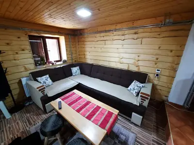 a living room with a couch and a table at Vikendica PAM in Vlasic