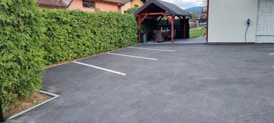 a parking lot in front of a building at Aman Guesthouse in Bihać