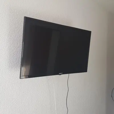a flat screen tv hanging on a wall at Aman Guesthouse in Bihać
