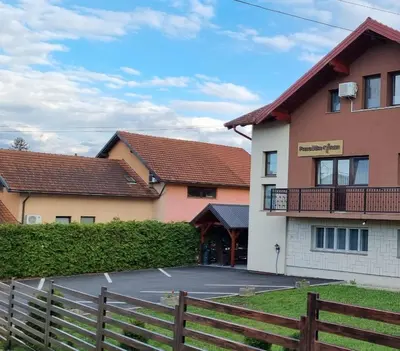 a parking lot in front of a building at Aman Guesthouse in Bihać