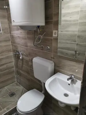 a bathroom with a toilet and a sink at Lux bungalow in Foča
