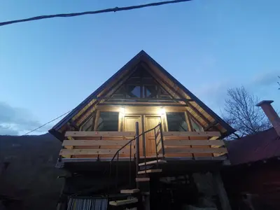 a log cabin with a porch and a front door at Lux bungalow in Foča