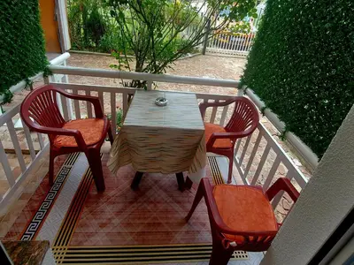 a wooden table and two chairs on a balcony at Apartmani GS ***** Zavidovici in Zavidovići
