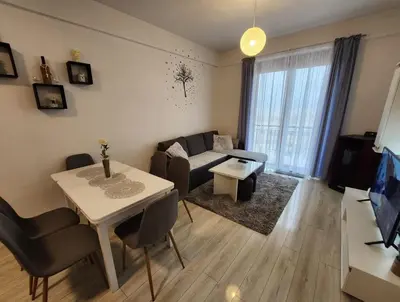 a living room with a couch and a table at Apartman Panorama in Kupres