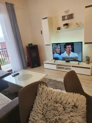 a living room with a flat screen tv and a couch at Apartman Panorama in Kupres
