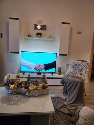 a living room with a tv and a table at Apartman Panorama in Kupres