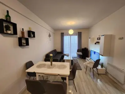 a living room with a table and a couch at Apartman Panorama in Kupres