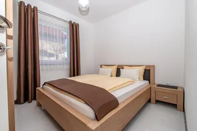 a bedroom with a bed and a window at Hazam Aparthotel in Sanski most