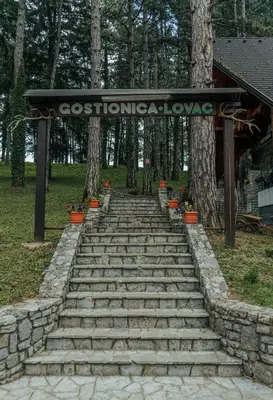a set of stone steps leading up to a sign at Prenoćište/Restoran Lovac in Bihać