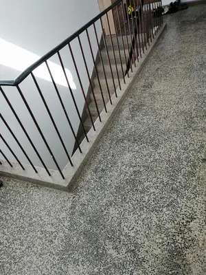 a staircase with a metal railing on a floor at Apartman EDEN No 1 in Teslić