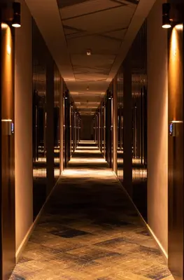 a hallway of a building with columns and lights at Hotel Biss in Zenica