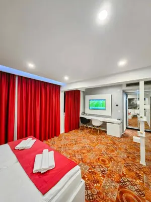 a bedroom with a bed and a flat screen tv at Hotel Biss in Zenica