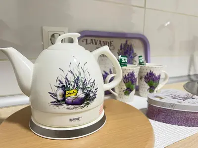 a white tea kettle sitting on a counter with vases at Korzo Tuzla in Tuzla