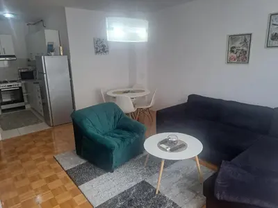 a living room with a couch and a table at Apartman Carica in Visoko