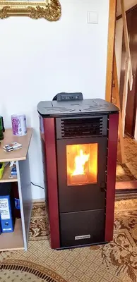 a stove sitting in a room with a fire in it at Cozy House in Jazvine with Garden in Jazvine