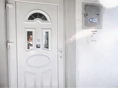 a white door with a picture on it at Cozy House in Jazvine with Garden in Jazvine