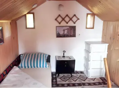 a small room with a bed and a desk at Cozy House in Jazvine with Garden in Jazvine