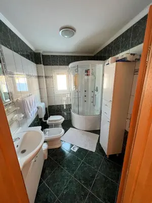 a bathroom with a sink and a toilet and a shower at Kuća Vesna in Kupres