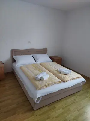 a bedroom with a bed with two towels on it at Kuća Vesna in Kupres