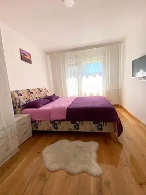 a bedroom with a bed and a white rug at Banja Luka 03 in Banja Luka