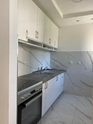 a white kitchen with a sink and a stove at Banja Luka 03 in Banja Luka