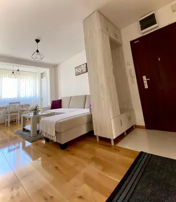 a living room with a couch and a large cabinet at Banja Luka 03 in Banja Luka