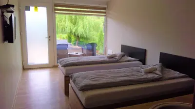 two beds sitting in a room with a window at Bungalovi Ključ in Ključ