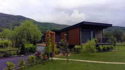 a small house in the middle of a yard at Bungalovi Ključ in Ključ