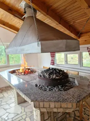a fire pit with a cake on top of it at Apartmani Vila in Kupres