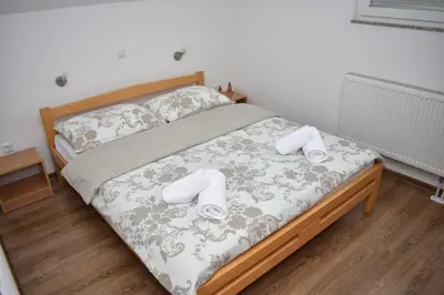 a bedroom with a bed with two towels on it at Apartmani Vila in Kupres