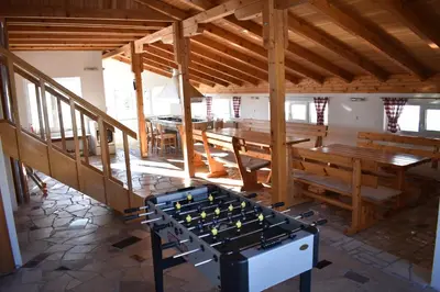 a room with benches and tables in a building at Apartmani Vila in Kupres
