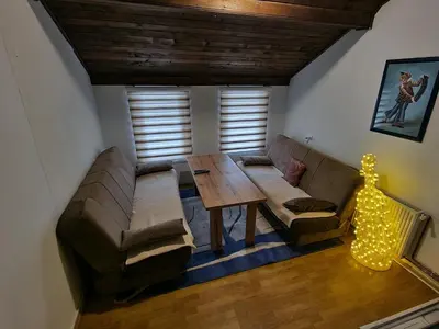 a living room with a couch and a table at Winter Forest Vlasic in Travnik
