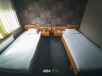 two beds in a small room with at Garni Motel Aba in Travnik