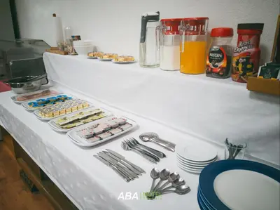 a counter top with a bunch of donuts and plates at Garni Motel Aba in Travnik