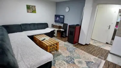 a living room with a couch and a table at Vlašić vikendica BHL in Šišava